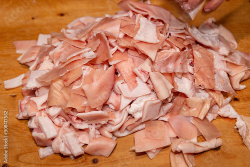 winter processing pork meat bacon cotechini zamponi and sausage photo