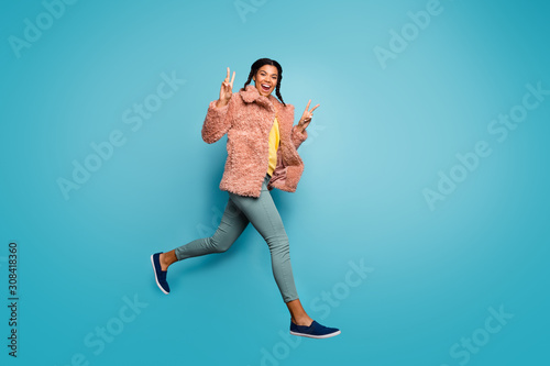 Fototapeta Naklejka Na Ścianę i Meble -  Full length body size view of nice attractive trendy fashionable cheerful cheery girl jumping running showing v-sign isolated on bright vivid shine vibrant green blue turquoise color background