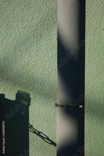 Utility pole and green outer wall   