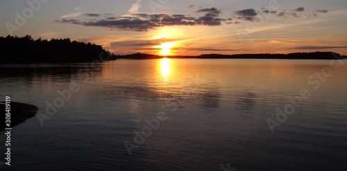 in the calm lake, the golden sunset is reflected