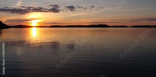 in the calm lake  the golden sunset is reflected