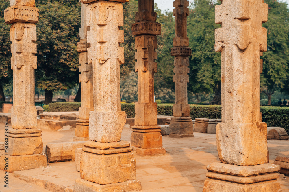 Ruins and columns in the ancient Qutub Minar complex in New Delhi India, a world heritage site