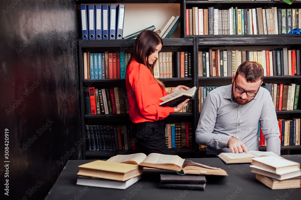 a man with a woman in the library prepared for the exam read books a man with a woman in the library prepared for the exam read books