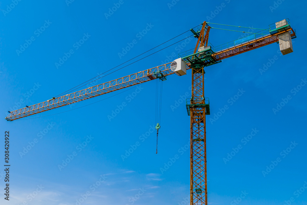 Construction site background. Hoisting cranes and new multi-storey buildings. I.ndustrial background.Building construction site work against blue sky Construction site background. Hoisting cranes and new multi-storey buildings. I.ndustrial background.Building construction site work against blue sky