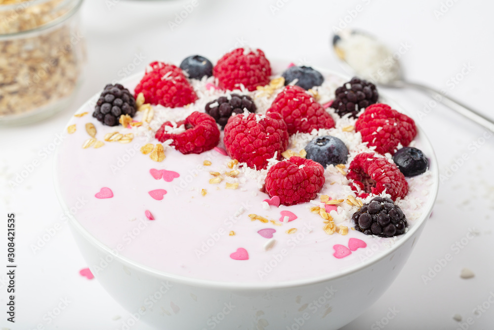 Breakfast smoothie bowl with yogurt, fresh raspberries, blueberries, BlackBerry, coconut flakes and granola. Healthy food. Breakfast smoothie bowl with yogurt, fresh raspberries, blueberries, BlackBerry, coconut flakes and granola. Healthy food.