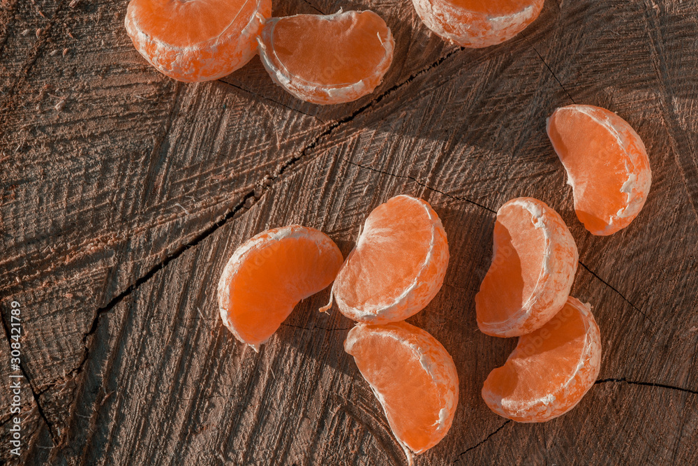 tangerine slices on a wooden background tangerine slices on a wooden background