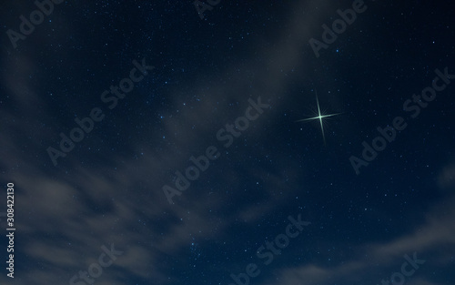 Obraz na płótnie Christmas star rising in North Carolina with light clouds in the night sky. w salonie