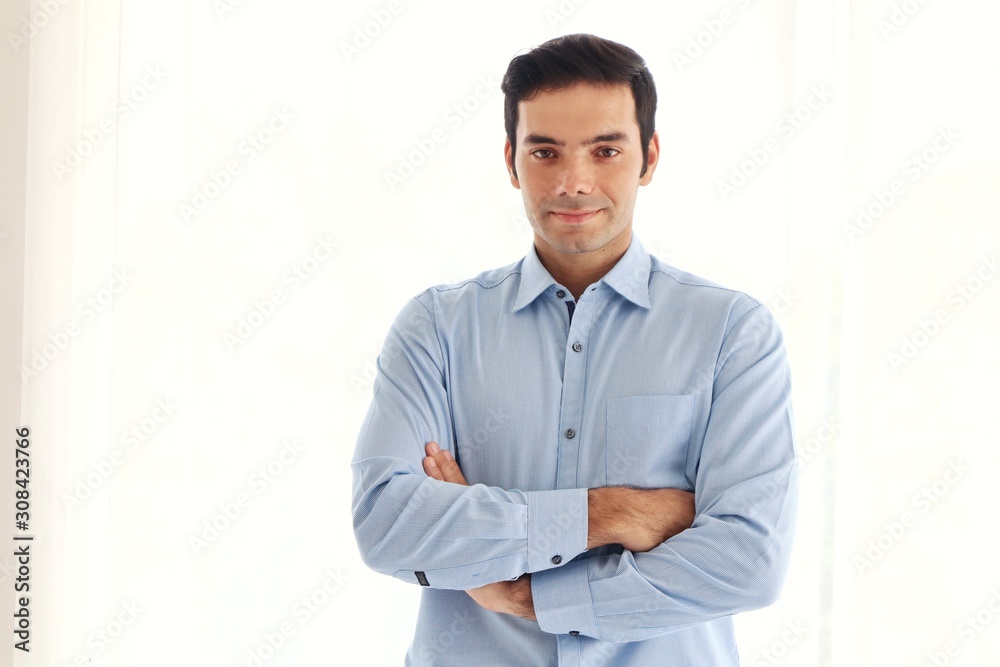 Handsome man standing in the office, close up shot, looking at camera 