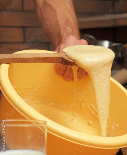 Mixing batter. Making yeast pancakes (crepes). photo