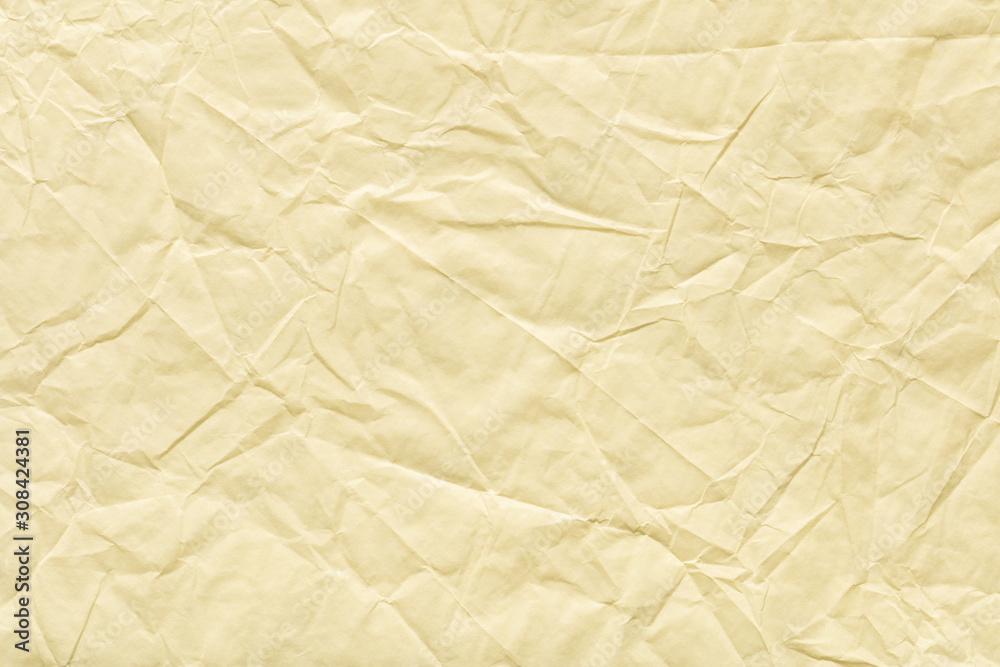 Fototapeta premium Crumpled paper background in light beige color for your greeting gift.
