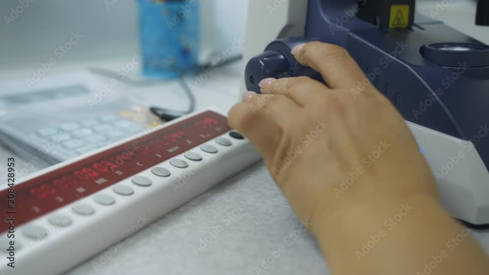 Female laboratory assistant working with microscope in medical laboratory. Female laboratory assistant working with microscope in medical laboratory.