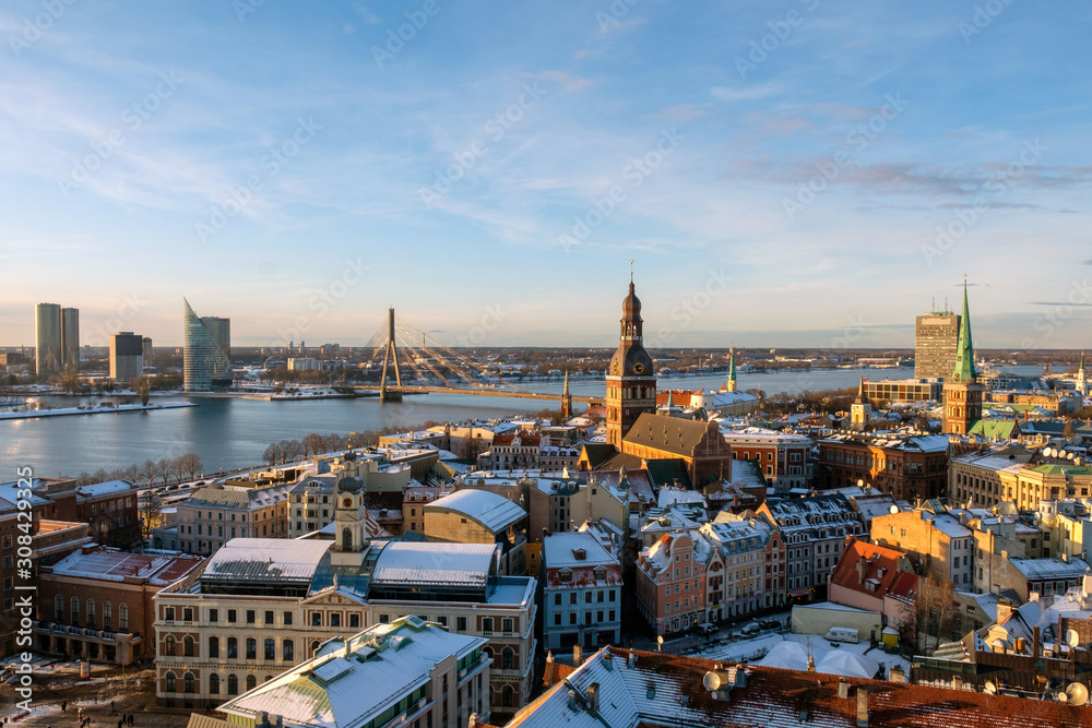 Riga / Latvia - 01 December 2019:Beautiful aerial Riga view from above. View from the St. Peters cathedral. Sunny winter day, roofs in snow Riga / Latvia - 01 December 2019:Beautiful aerial Riga view from above. View from the St. Peters cathedral. Sunny winter day, roofs in snow