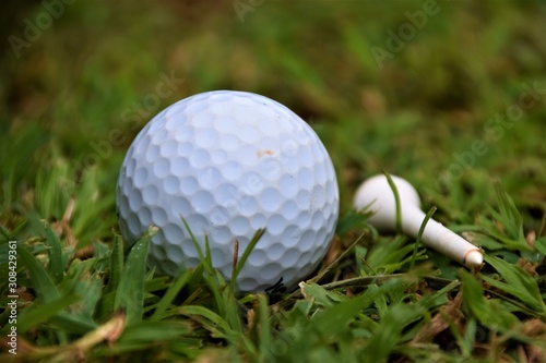Golf ball and white tee closeup detail
