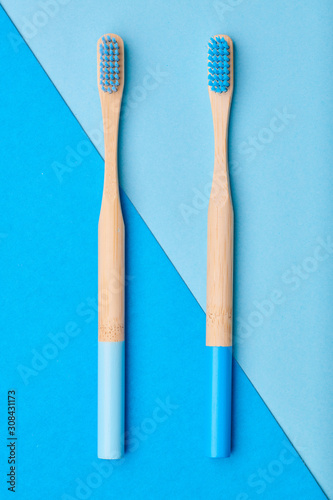 Toothbrushes on blue background top view. Tooth care  dental hygiene and health concept.