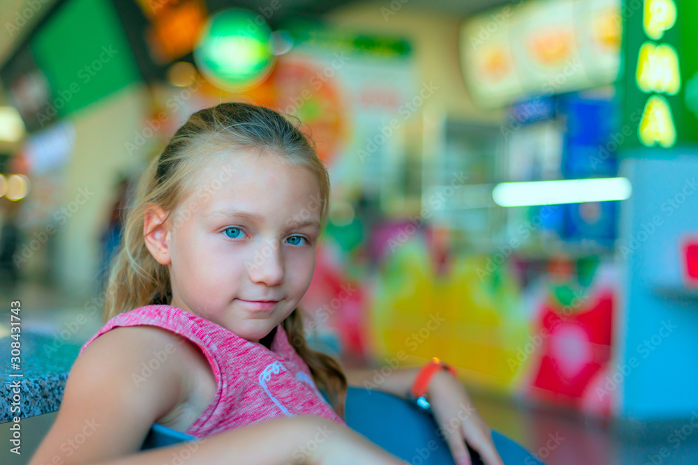 Girl sitting in a cafe in a shopping center Girl sitting in a cafe in a shopping center