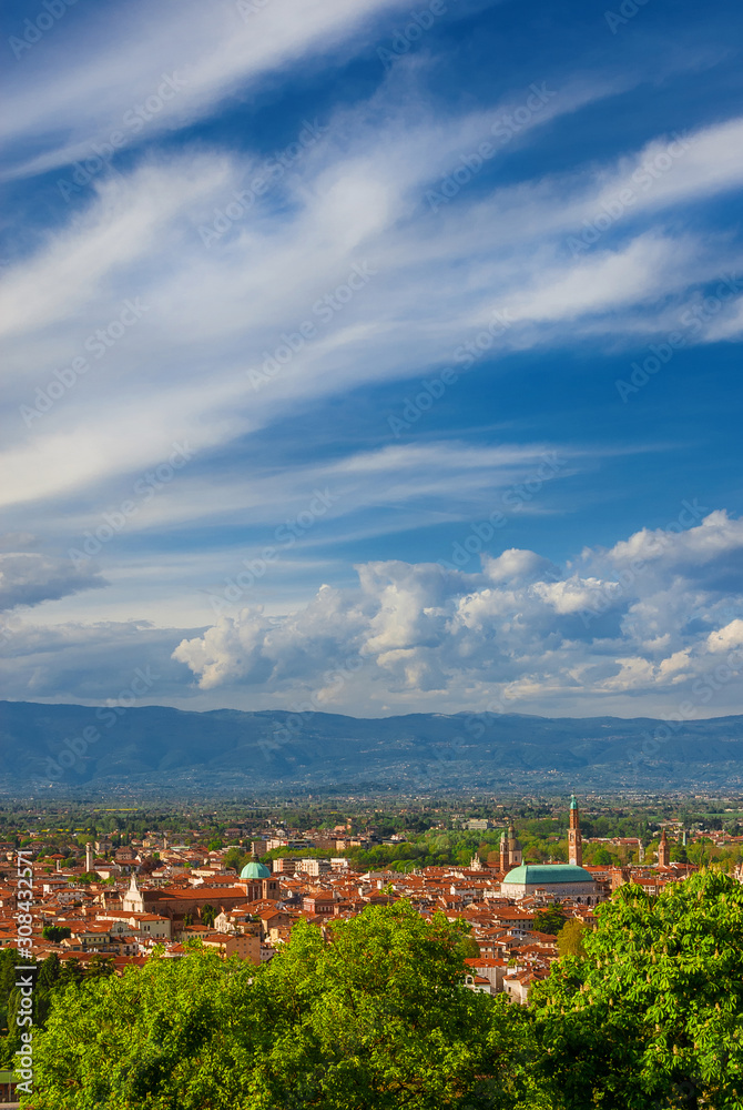 View of Vicenza historic center with the famous renaissance Basilica Palladiana adn cathedral with clouds above, from Mount Berico panoramic terrace