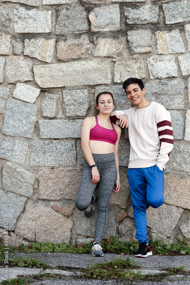 Portrait of a couple of runners looking at camera and smiling Portrait of a couple of runners looking at camera and smiling