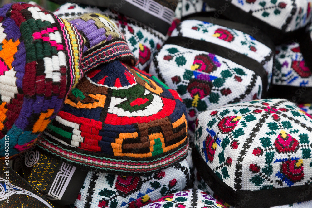 Bright multi-colored Uzbek skullcaps close-up
