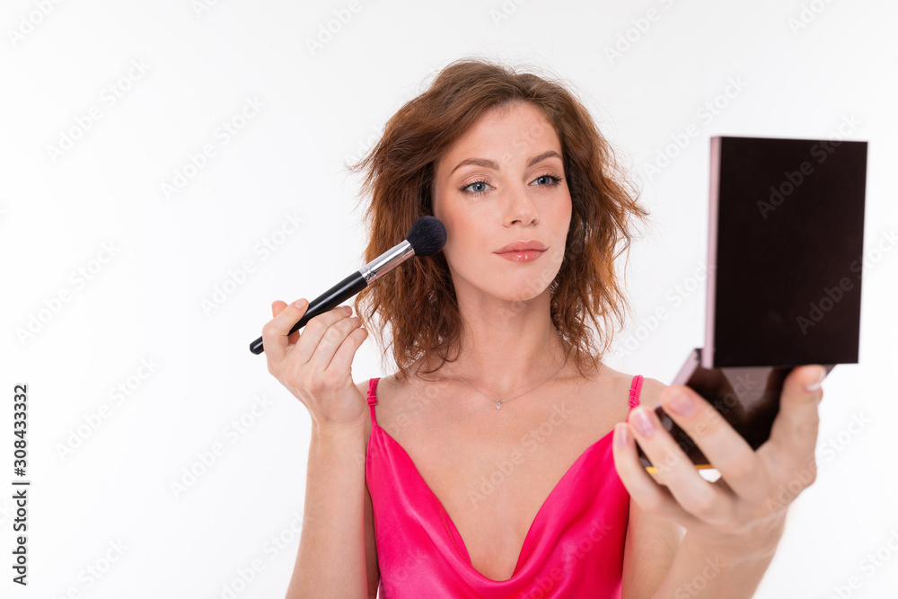 Young beautiful girl do makeup with little mirror isolated on white background Young beautiful girl do makeup with little mirror isolated on white background