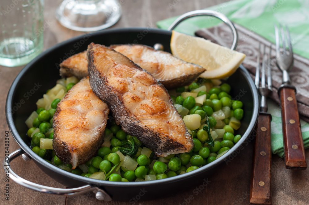 Pan Seared Halibut with Sauteed Peas and Lemon Wedge