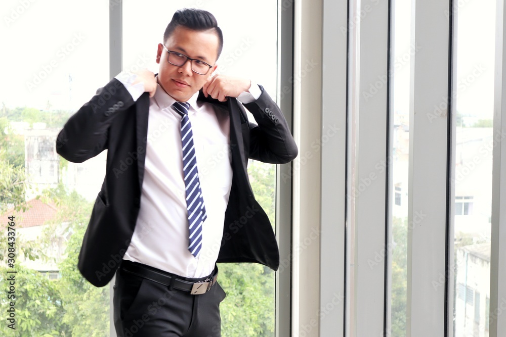 Asian businessman standing in the office Asian businessman standing in the office