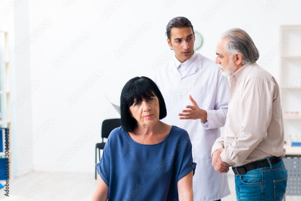 Old couple visiting young male doctor Old couple visiting young male doctor