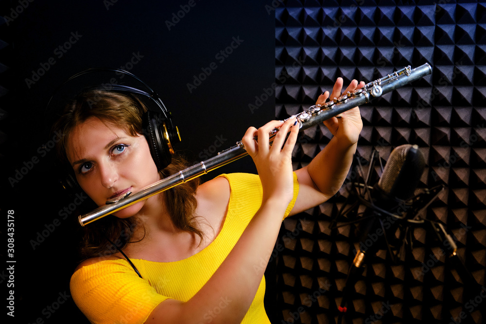 Record wind musical instruments with a professional microphone. Girl