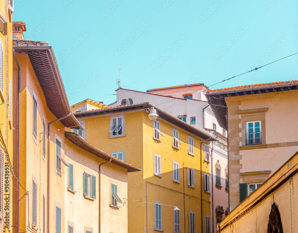 Typical italian street view cityscape in a summer day under light blue sky