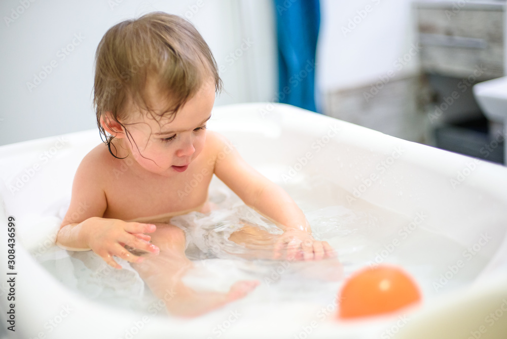 1 year old Baby in bathtub taking bath in bathroom Stock Photo Adobe