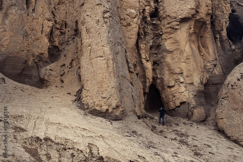 Traveler exploring caves in mountain area