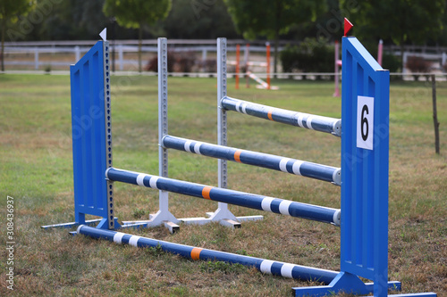 Image of show jumping poles on empty training field.