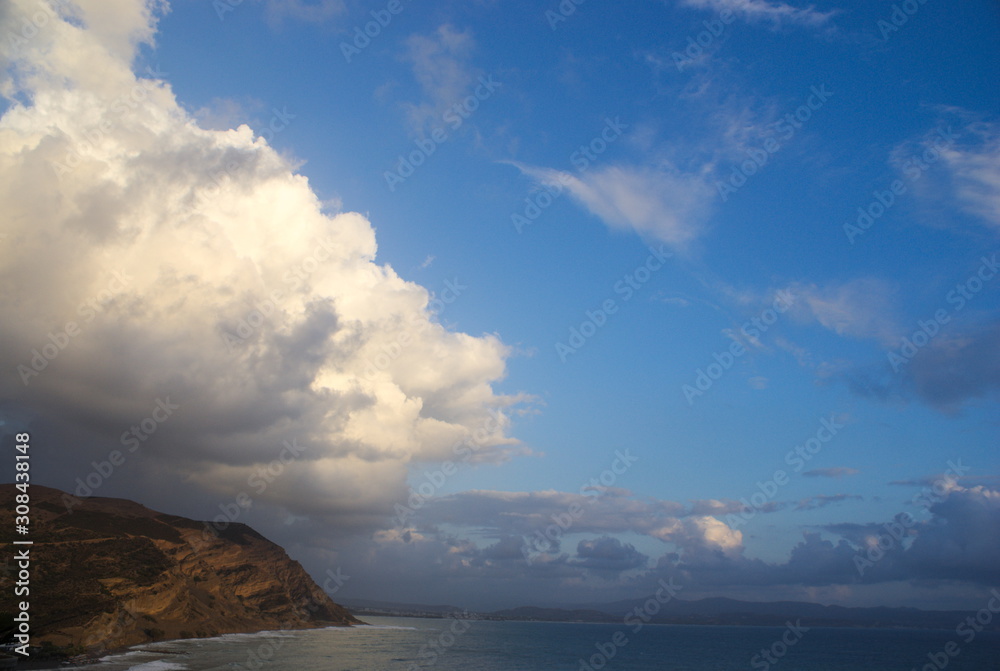 View of clouds over the sea and cliffs, at the resort of Agia Galini on the beautiful Greek island of Crete. 