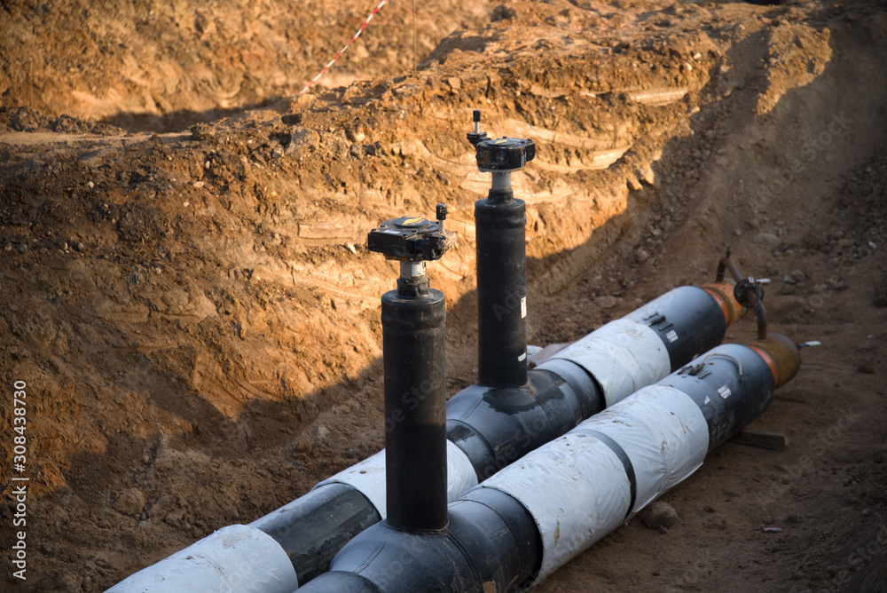 Laying of underground storm sewer pipes. Installation of water main, sanitary sewer. Plastic drainage pipe in ditch. Installation of concrete sewer wells in the ground at the construction site.