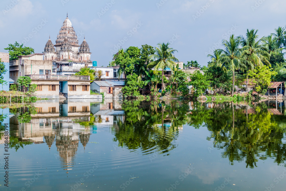 Shiva temple reflecting in a pond in Puthia village, Bangladesh