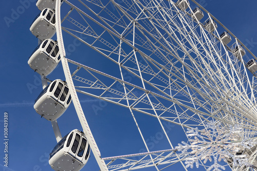 Close up detail of a white Ferris wheel at a funfair