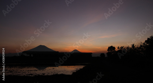 the beauty of the sunset with beauty reflection of mountains in Magelang  Central Java   Indonesia