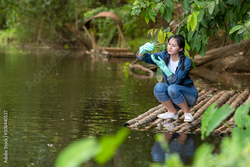 Canvas Print Asian student biology taking and testing sample of natural river water