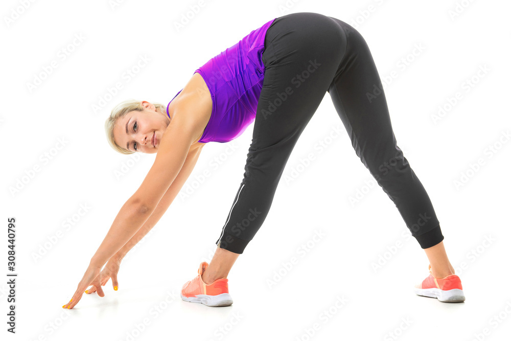 European blonde girl performs physical exercises on a white studio background European blonde girl performs physical exercises on a white studio background