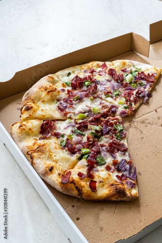 Flammkuchen Pizza Slices / Traditional Tarte Flambee with Creme Fraiche, Cream Cheese, Bacon and Red Onions in Box.