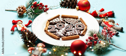 New Year and Christmas chocolate gingerbread cookies in silhouette of 2020. Homemade delicious bakery, sweet family time and traditions.