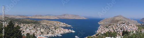 A panoramic view of the port of the Greek island of Symi. Picture taken at height from the mountains that encircle the bay.