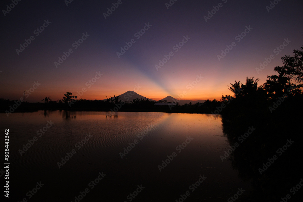 the beauty of the sunset with beauty reflection of mountains in Magelang, Central Java / Indonesia the beauty of the sunset with beauty reflection of mountains in Magelang, Central Java / Indonesia
