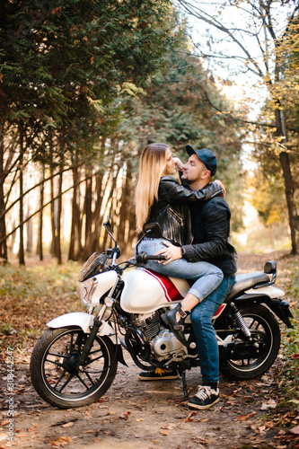 young couple on motorcycle laugh