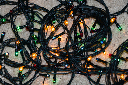 Electric lights need to be unraveled before decorating the christmas tree, isolated. photo