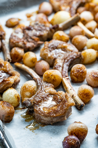Baked Lamb Chops with Shallots on Baking Tray with Paper Sheet.