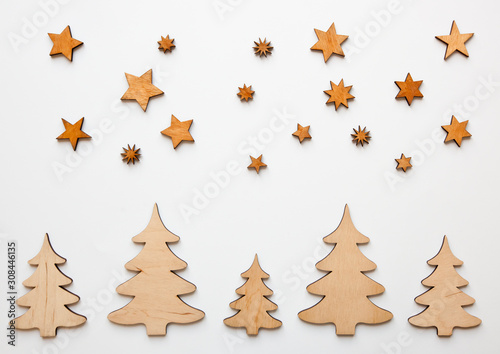 The beautiful christmas background with a lot of small wooden decorations on the white desk.