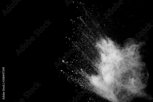 Freeze motion of white color powder exploding on dark background. 