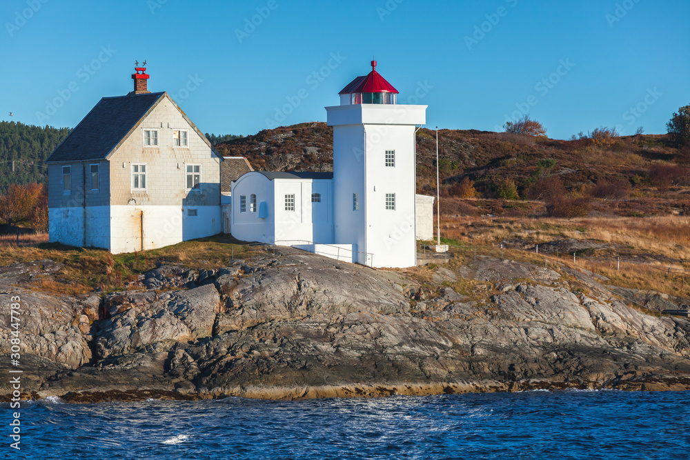 Terningen Lighthouse. White tower with red top. Norway