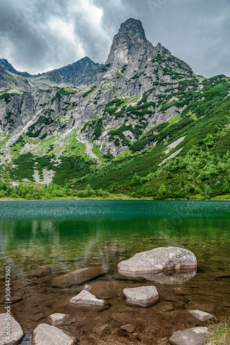 "Green Pond" (Zelene Pleso Kezmarske) in Slovakian High Tatra mountains with Jastrabia Veza peak towering in the background. Slovakia, Europe.