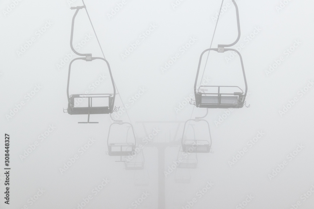 Empty ski chair lift in deep fog in Glen Coe, Scotland.